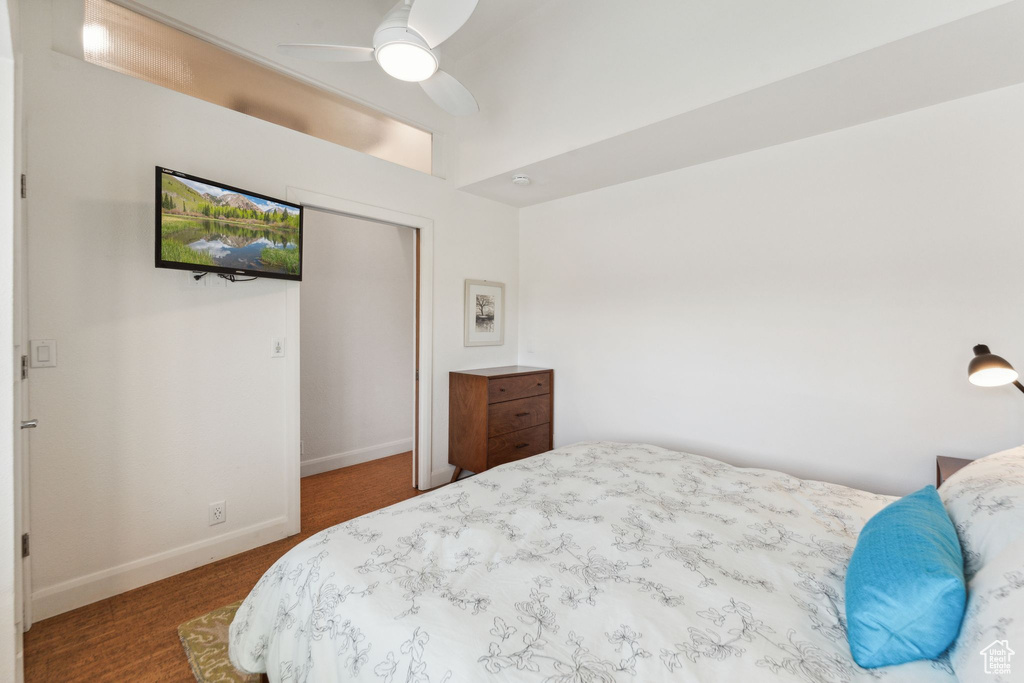 Carpeted bedroom with baseboards and ceiling fan