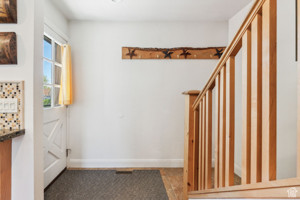 Doorway to outside featuring baseboards