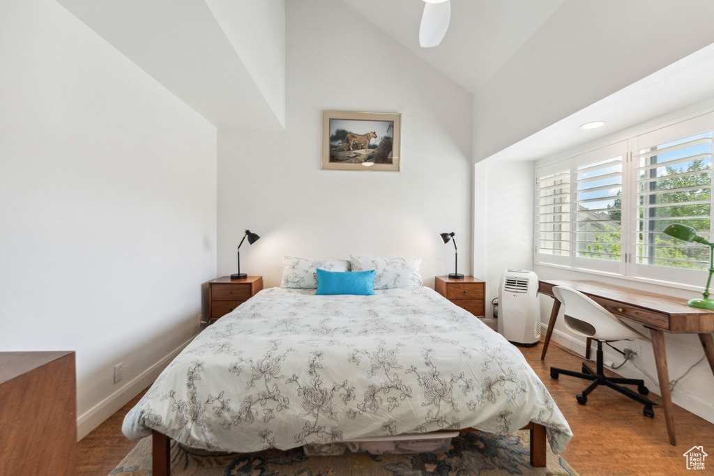 Bedroom with lofted ceiling and baseboards