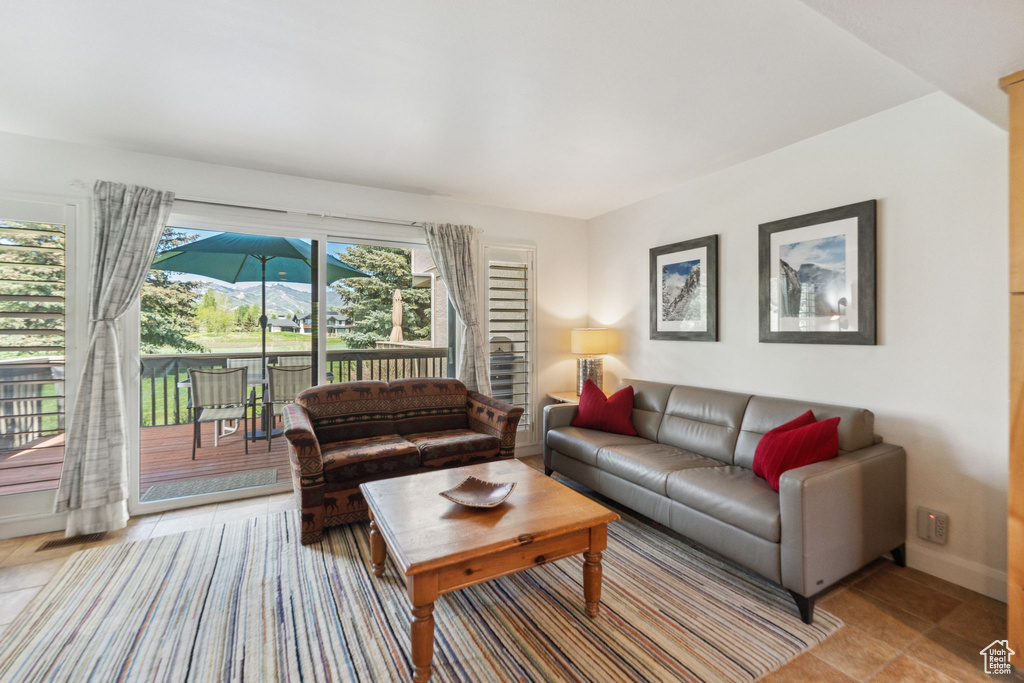 Living area featuring baseboards and light tile patterned floors