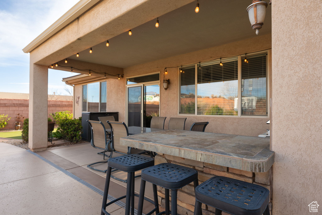 View of patio with fence and outdoor dining area