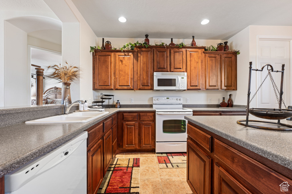 Kitchen featuring white appliances and sink