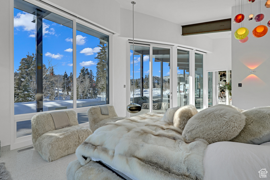 Bedroom featuring beam ceiling, multiple windows, and access to outside