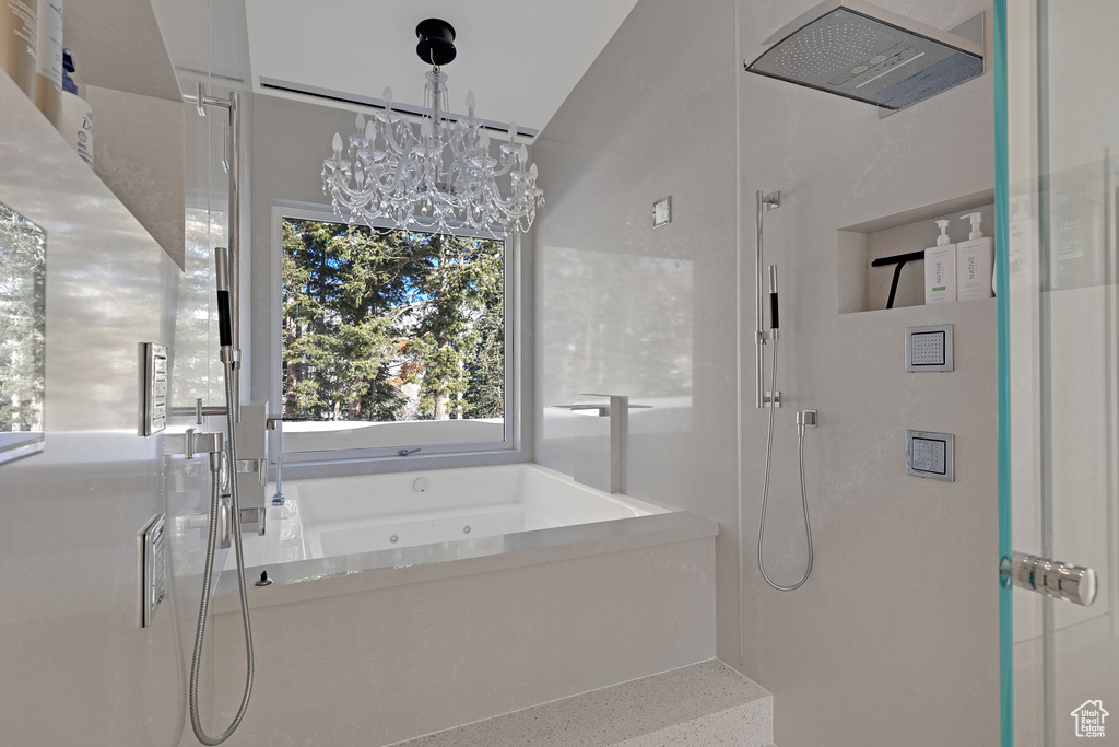 Bathroom with plus walk in shower and a chandelier