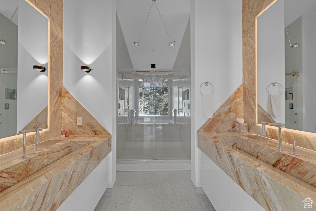 Bathroom featuring vaulted ceiling and walk in shower