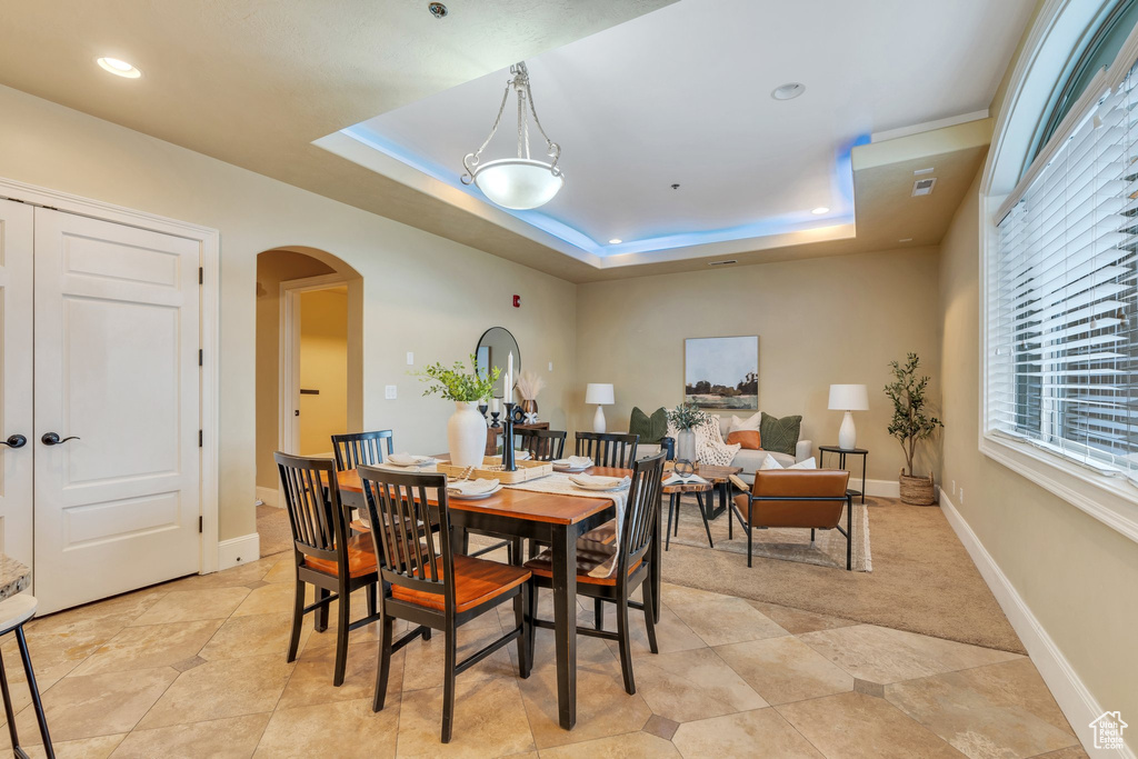 Dining area featuring a raised ceiling