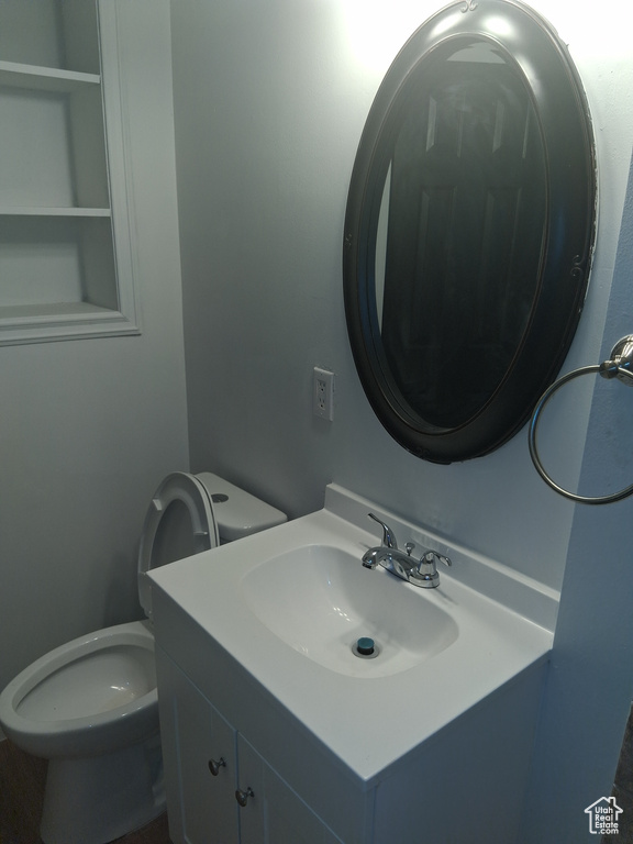Half bathroom with toilet and vanity