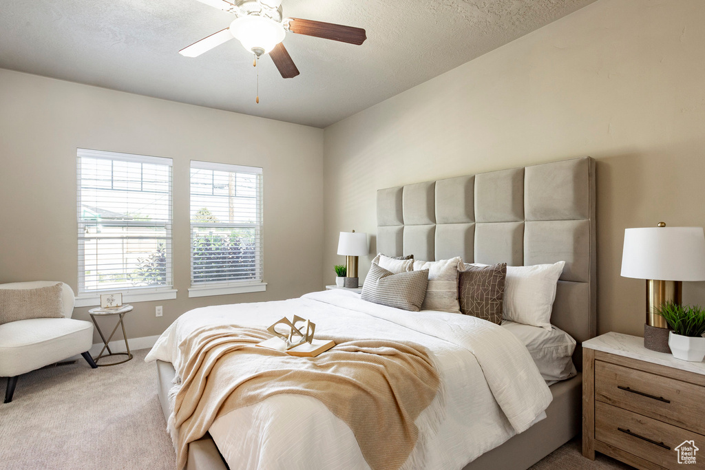 Bedroom featuring carpet flooring, baseboards, and a ceiling fan