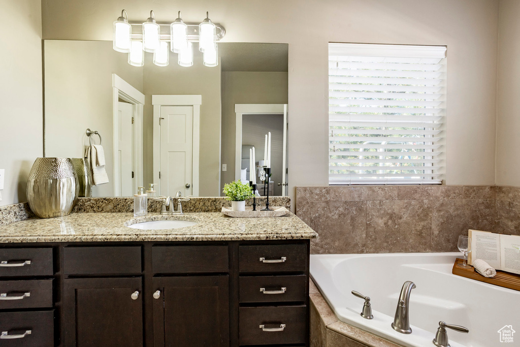 Full bath with vanity and a garden tub