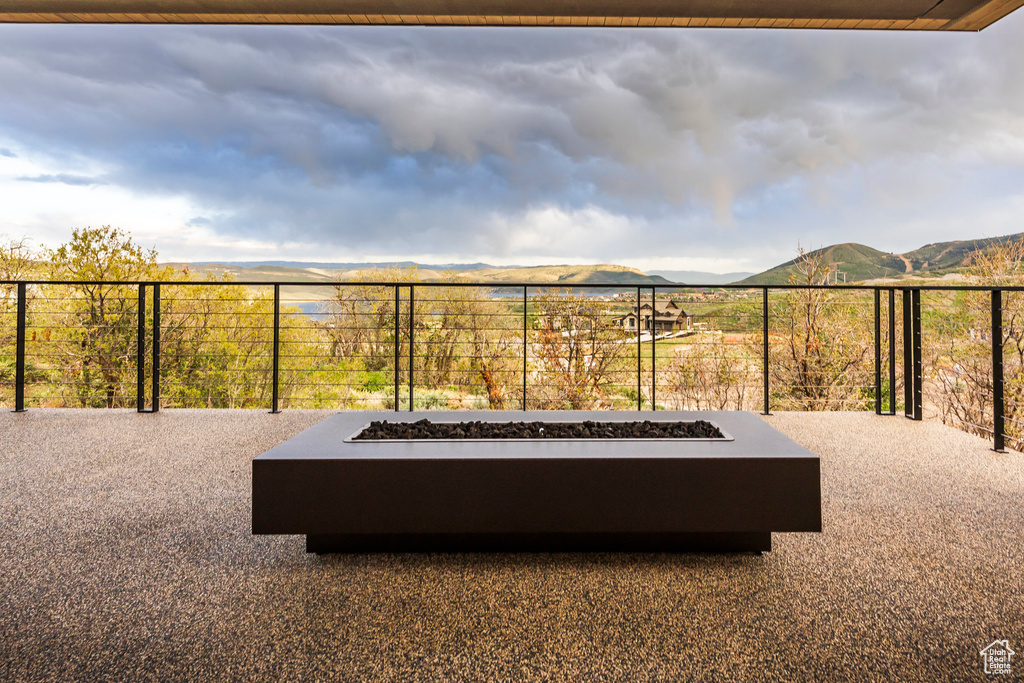View of patio with a fire pit and a mountain view