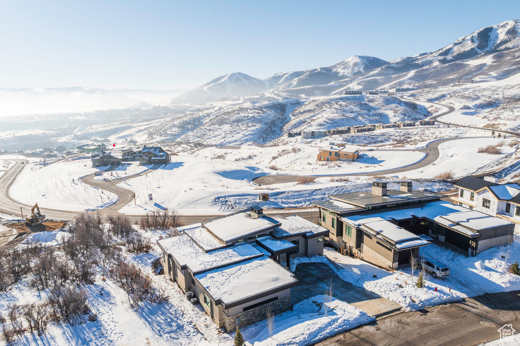 Snowy aerial view featuring a mountain view