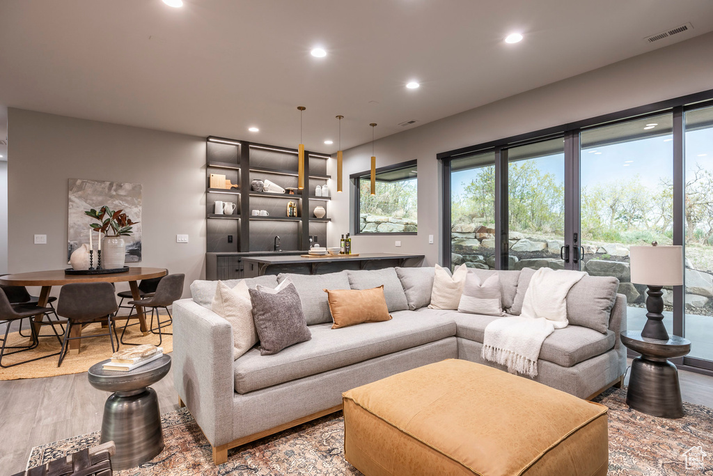 Living area featuring light wood-type flooring and recessed lighting