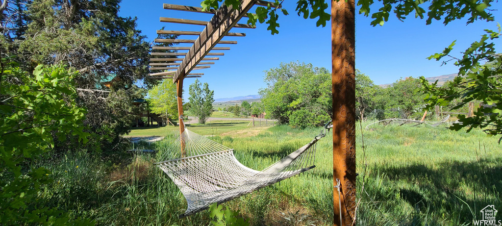 View of community featuring a pergola and a mountain view