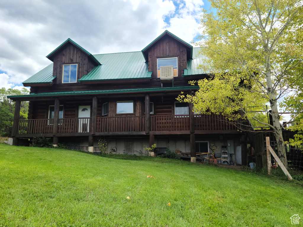 View of front of house featuring a front lawn and covered porch