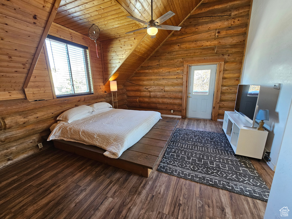 Bedroom with dark hardwood / wood-style flooring, rustic walls, ceiling fan, and wood ceiling