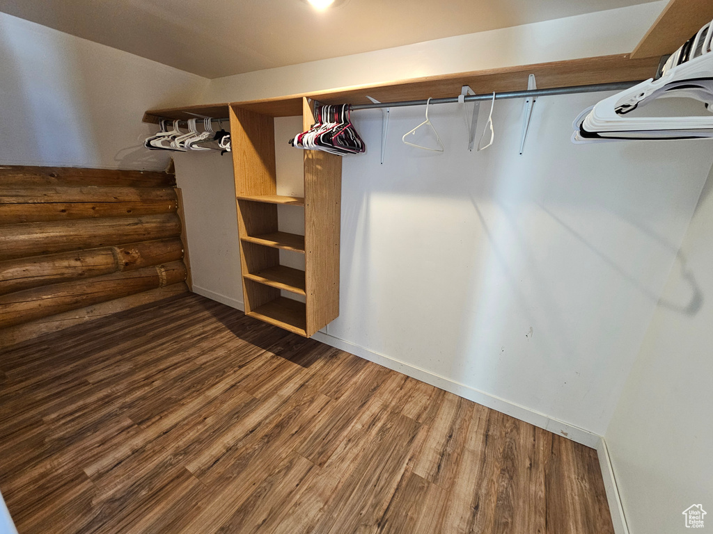 Spacious closet featuring hardwood / wood-style flooring