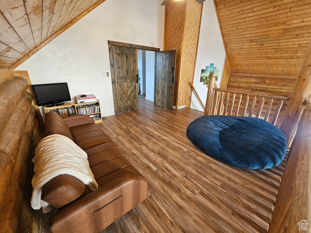 Living room with wood ceiling, wood-type flooring, and vaulted ceiling