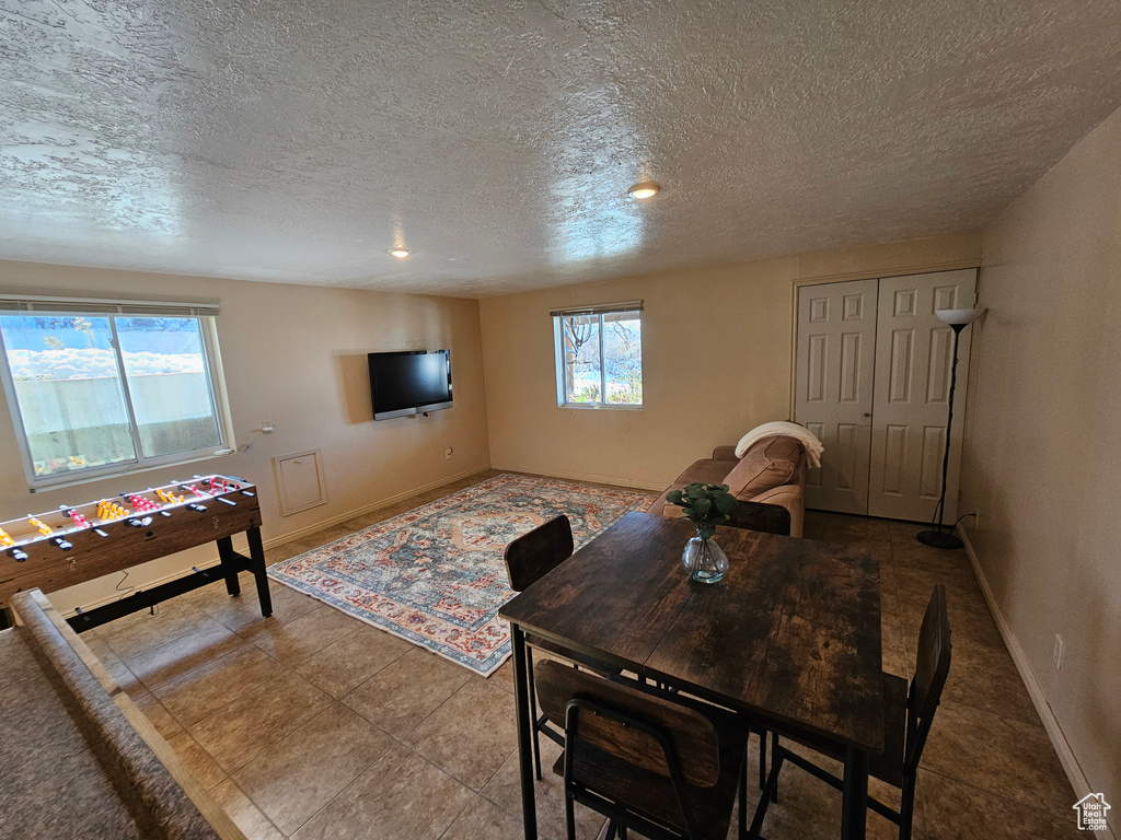 Tiled living room featuring a textured ceiling