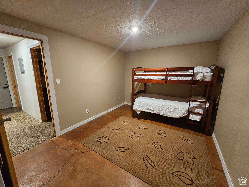 Carpeted bedroom with a textured ceiling