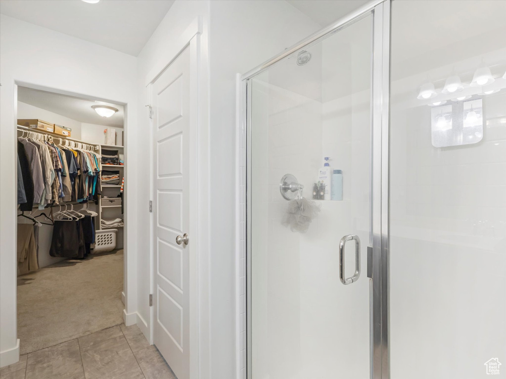 Bathroom featuring a shower with door