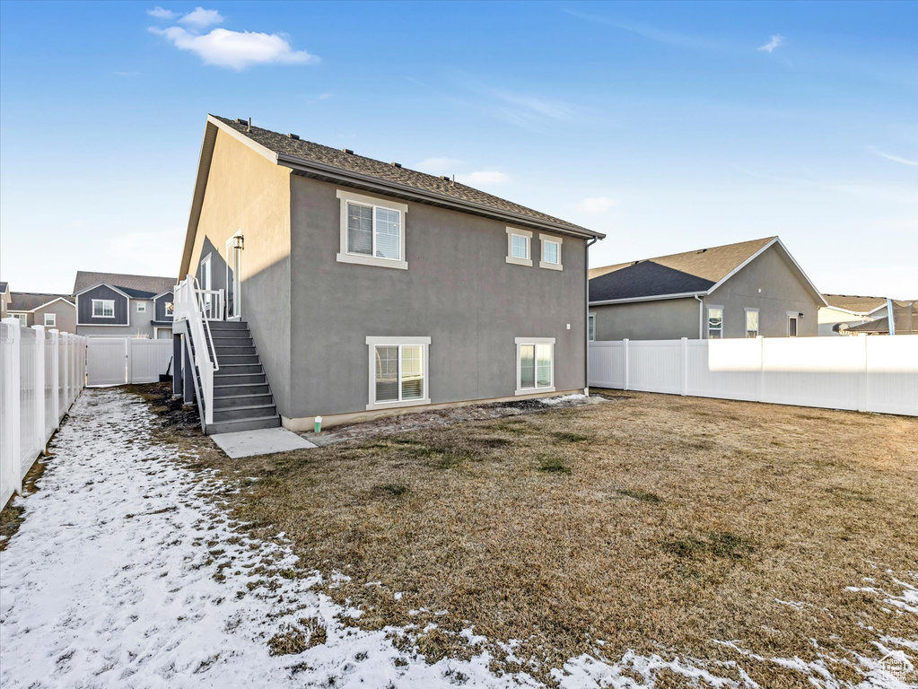 Snow covered house with a lawn