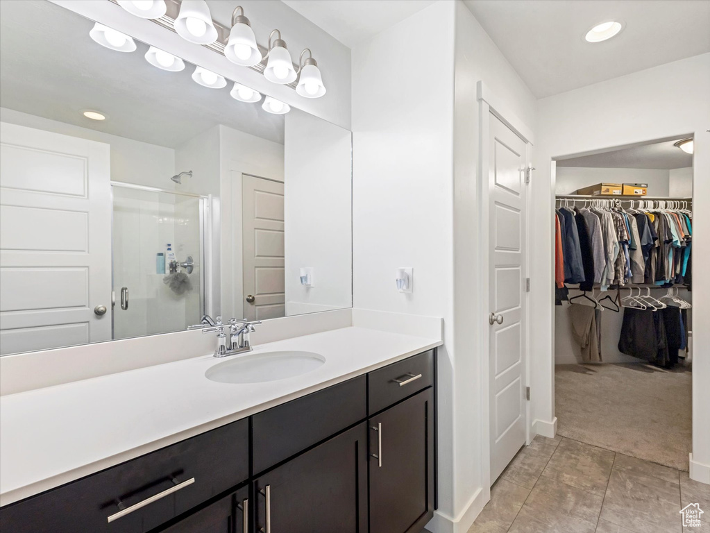 Bathroom featuring vanity and an enclosed shower