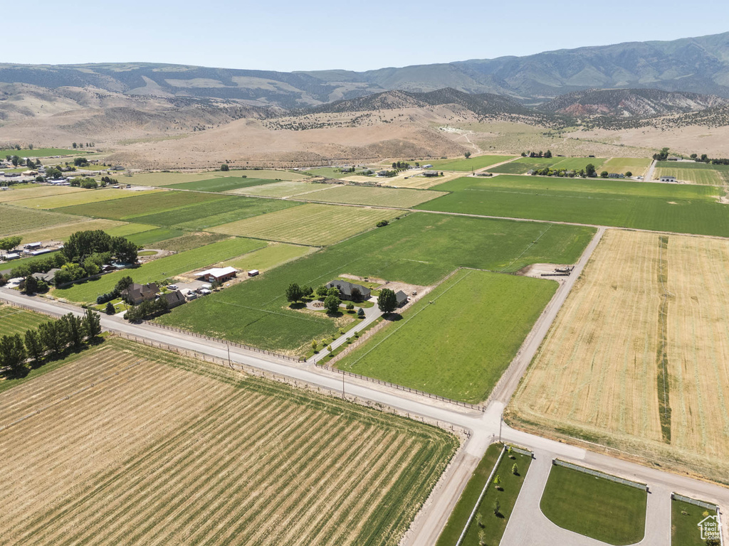Overview of rural landscape with extensive farmland and a mountainous background