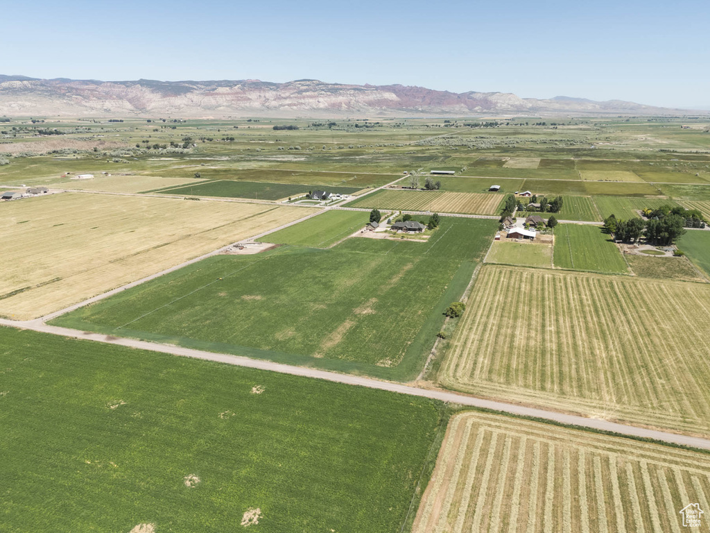 Aerial overview of property's location with rural landscape and a mountain backdrop