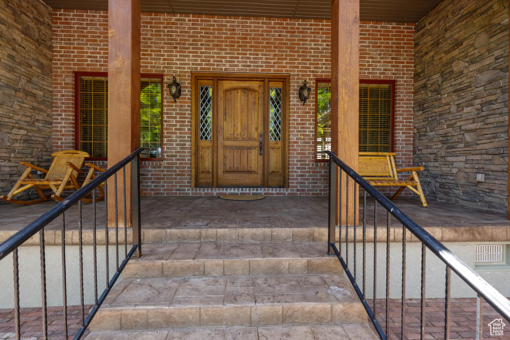 Doorway to property with brick siding