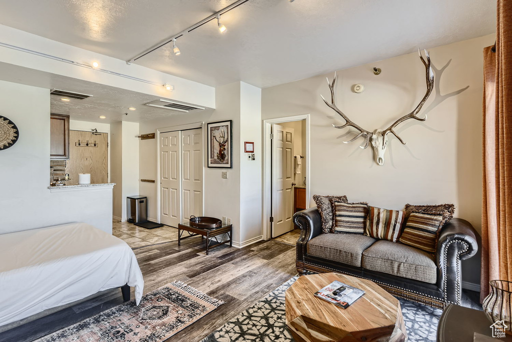 Bedroom featuring light hardwood / wood-style flooring and a closet