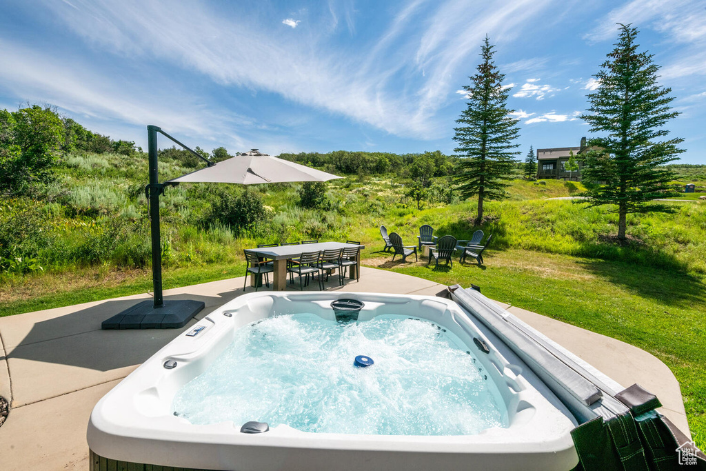 View of pool with a yard, a hot tub, and a patio