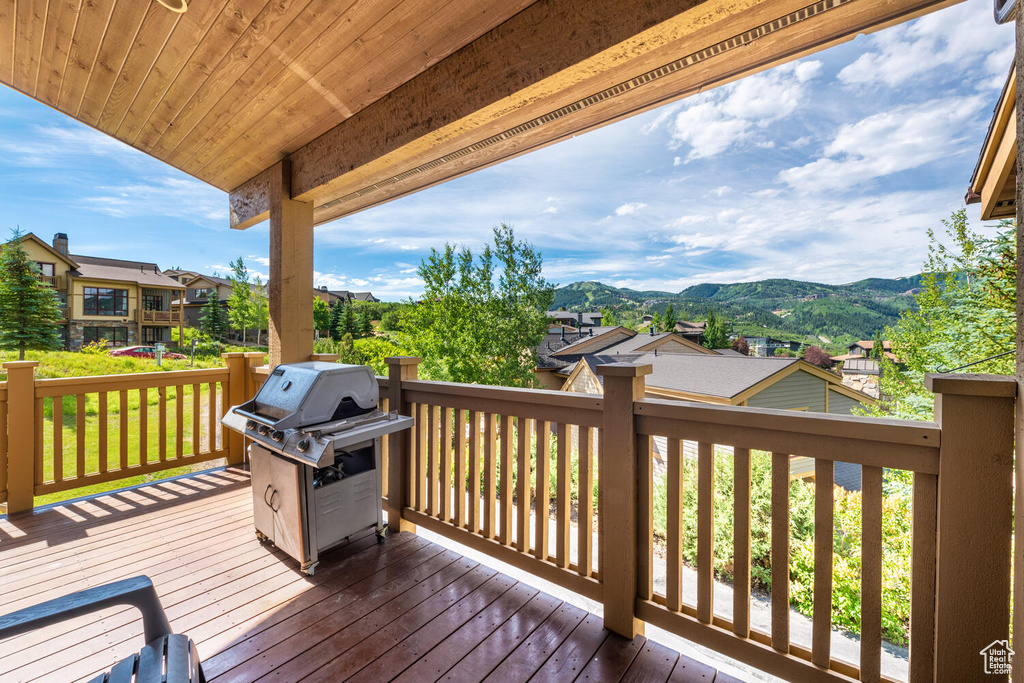 Wooden deck with area for grilling and a mountain view
