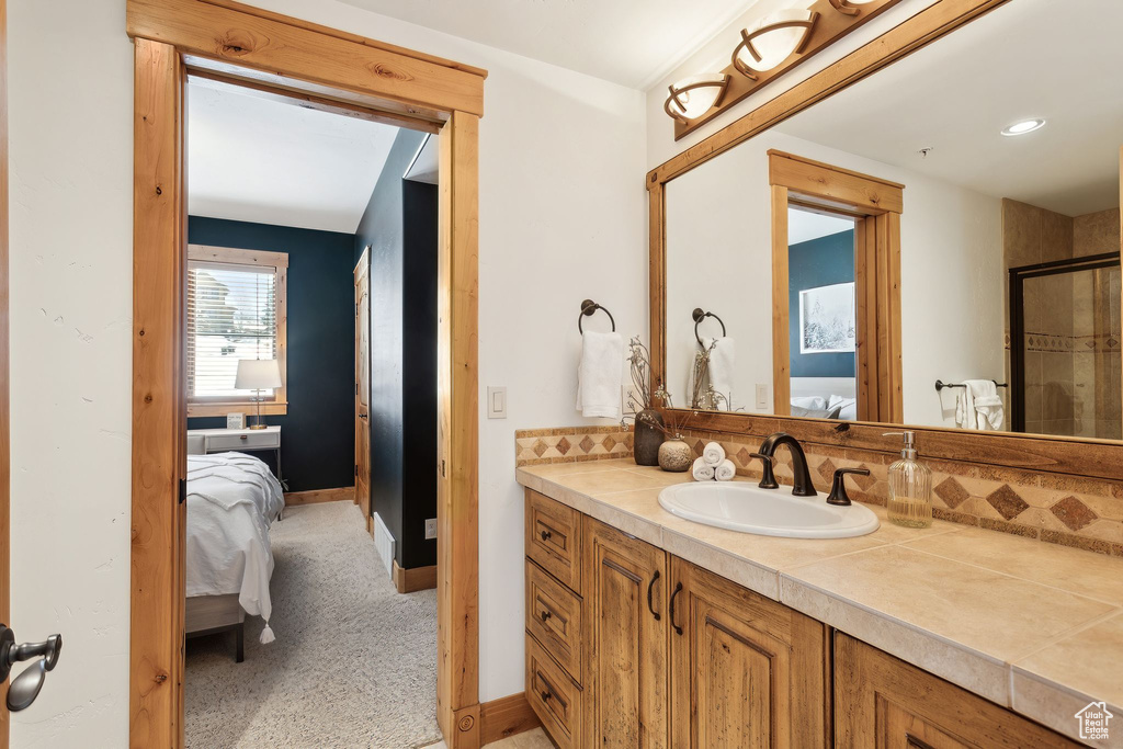 Bathroom with vanity and a shower with shower door