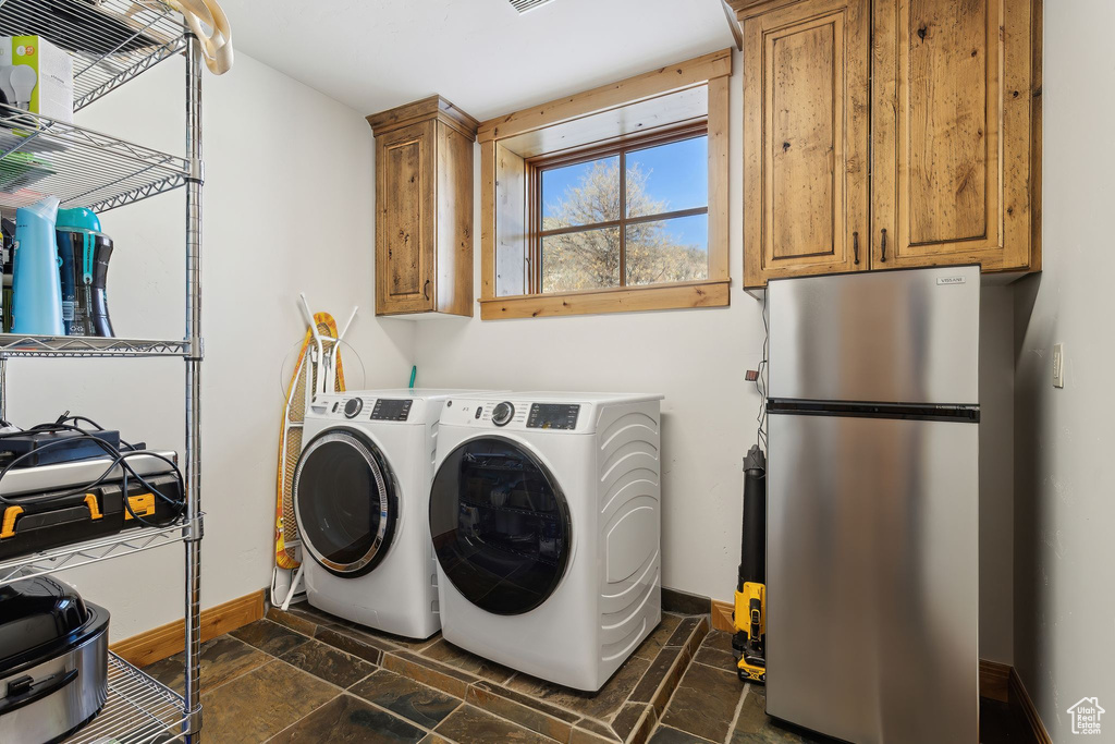 Laundry area with cabinets and separate washer and dryer