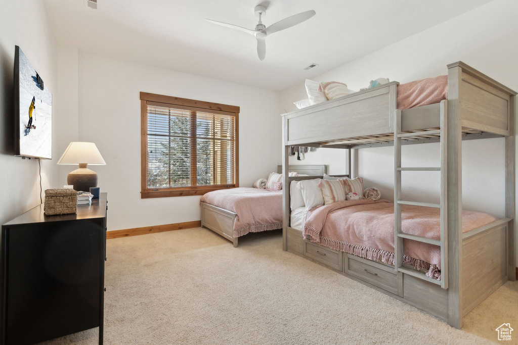 Carpeted bedroom with ceiling fan