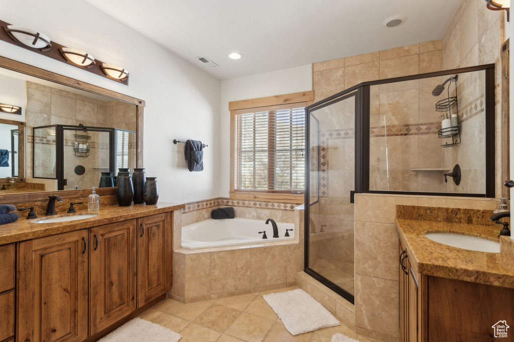 Bathroom with vanity, tile patterned flooring, and plus walk in shower