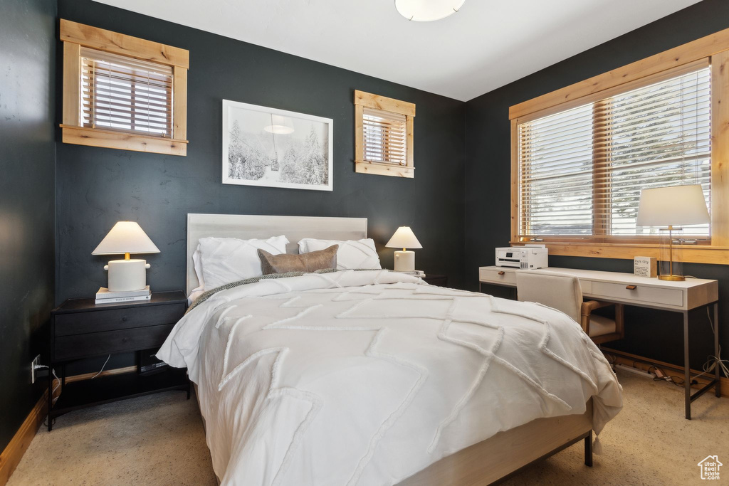 Bedroom with light colored carpet