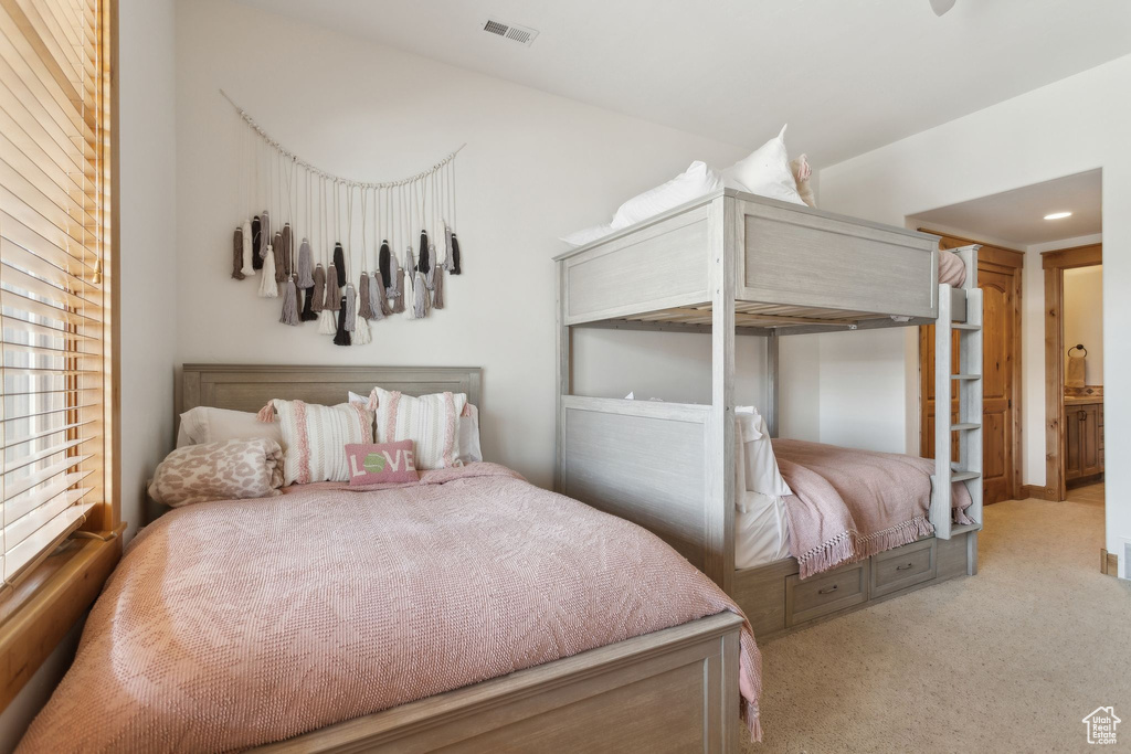 Bedroom with light colored carpet