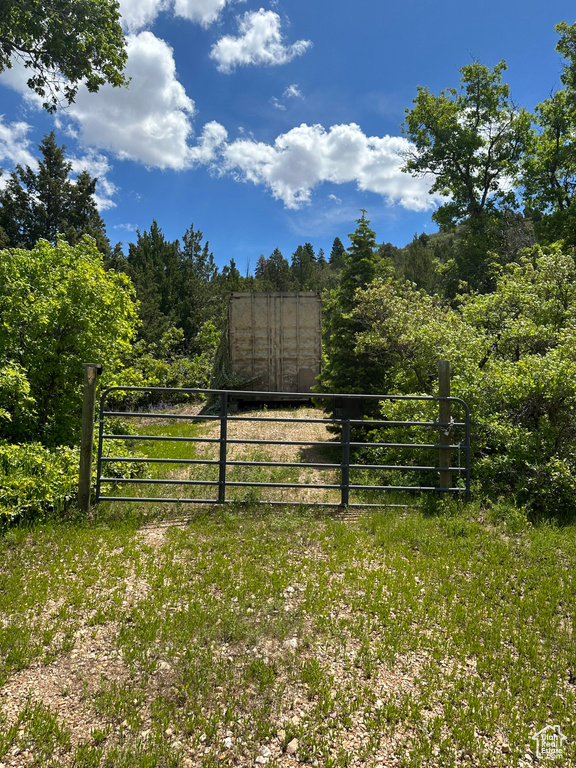 View of gate featuring a lawn