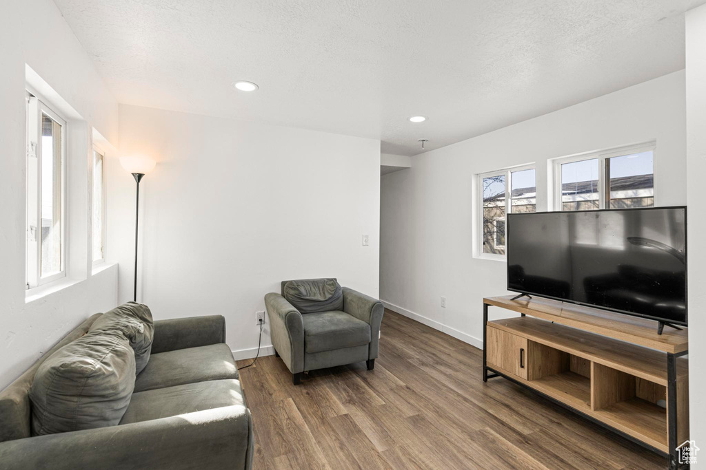 Living room with hardwood / wood-style floors and a textured ceiling