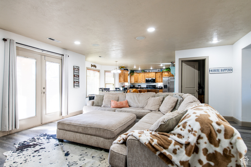 Living room with french doors and light hardwood / wood-style flooring