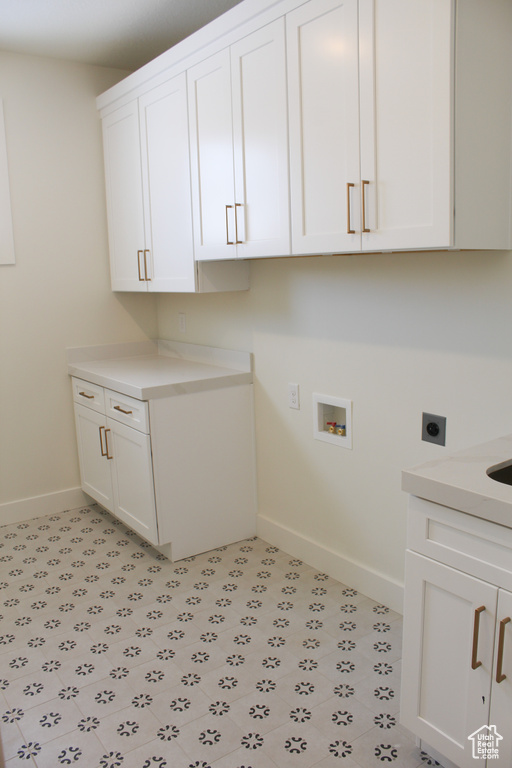 Laundry room with cabinets, washer hookup, and hookup for an electric dryer
