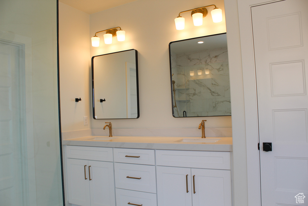 Bathroom featuring vanity and a shower
