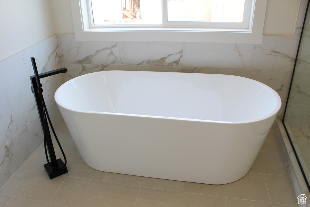 Bathroom featuring tile patterned flooring and a bathing tub