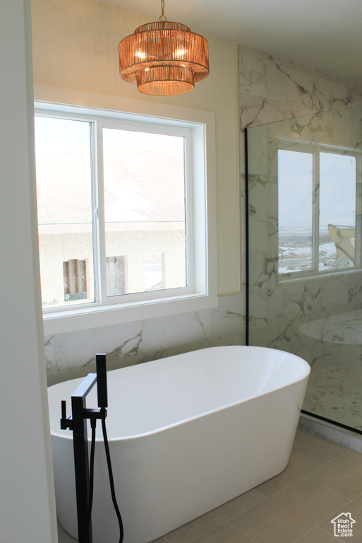 Bathroom featuring a washtub and tile patterned floors