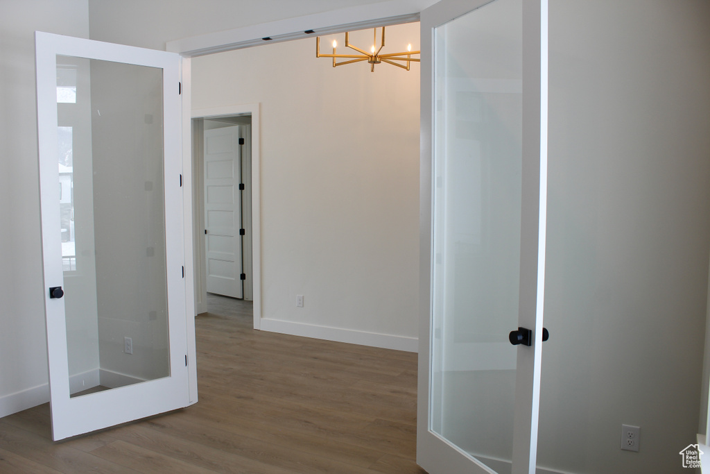 Interior space with hardwood / wood-style flooring and a notable chandelier