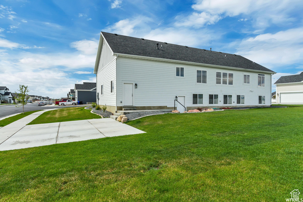 Back of property featuring a yard and a patio