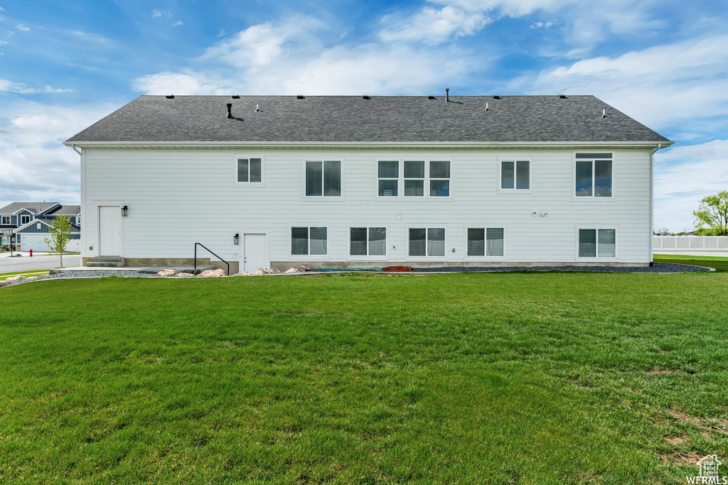Back of property with a yard
