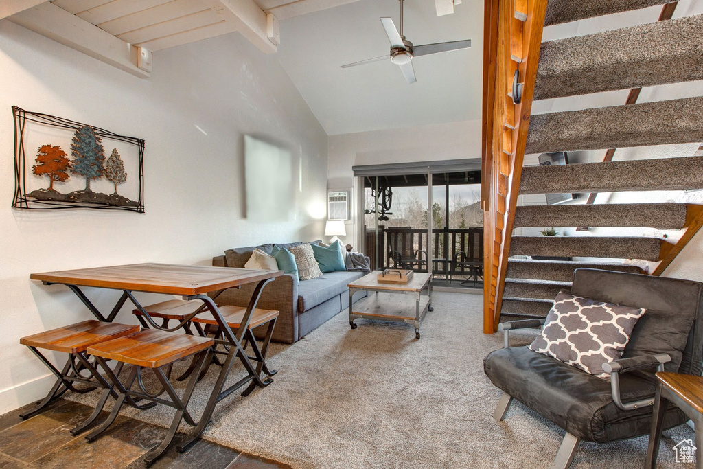 Living room featuring ceiling fan, beam ceiling, high vaulted ceiling, and carpet