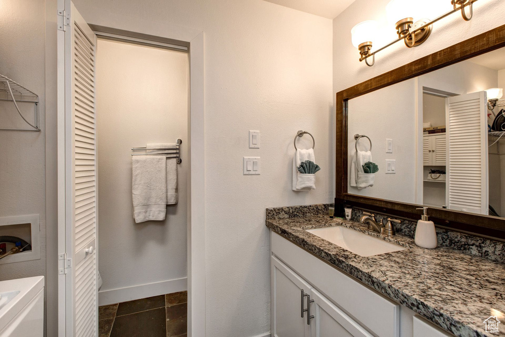 Bathroom featuring tile patterned flooring and vanity